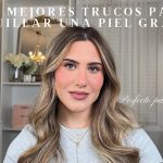 Thumbnail for a makeup tutorial about oily skin; woman with wavy hair sits at a bright vanity, caption shows 'Perfecto para principiantes' (inset text).